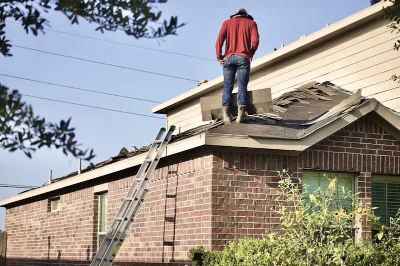 Professional roofer working on a residential roof in Fairborn